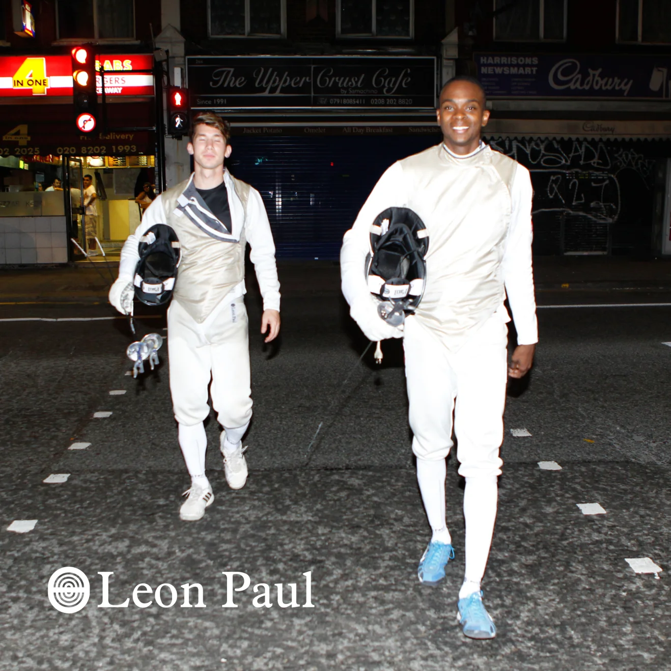 Leon Paul professional fencers in white uniforms holding fencing equipment on London street showcasing sport heritage